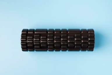 The TriggerPoint Grid 1.0 foam roller, a multi-density surface designed among top recovery tools to mimic a massage therapist's hands. 