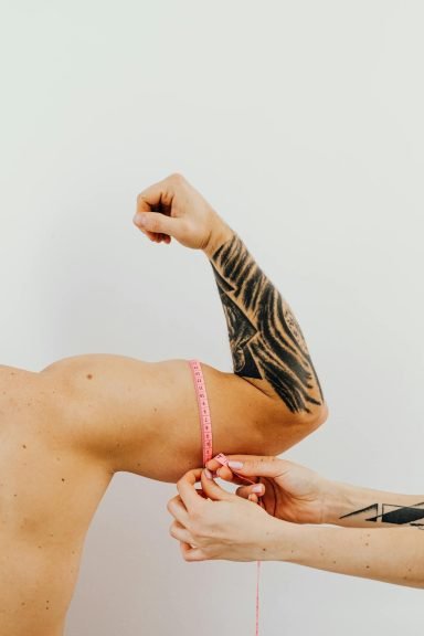 Using a soft tape measure for fitness progress tracking to identify muscle growth. 