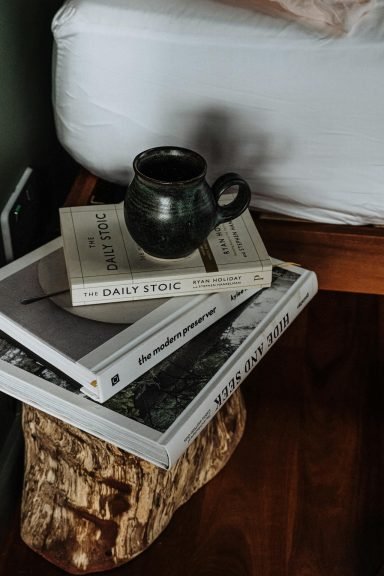 A stack of books including The Daily Stoic for building mental discipline and lasting habits