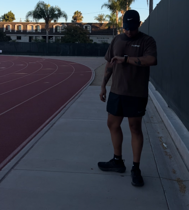 Runner wearing Nike Dri-FIT socks on a running track to prevent blisters.